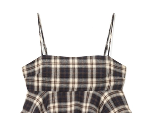 Detailed view of the plaid camisole top with adjustable thin straps and a ruffled hemline