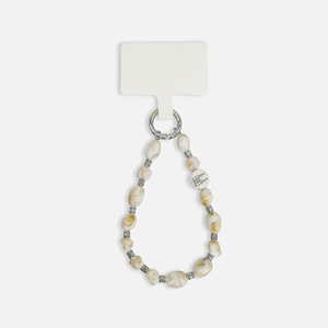 Macro detail of Bohemian phone strap with irregular marble-textured beads and silver spacers