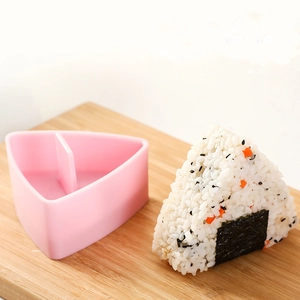 Pink triangular onigiri rice mold with seaweed rice ball on wooden board