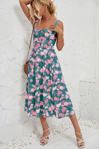 Detailed view of the chest lace-up design and floral print on a summer midi dress