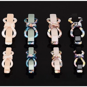 Elegant acetic acid bow hair clips with rhinestones in four colors on a black background