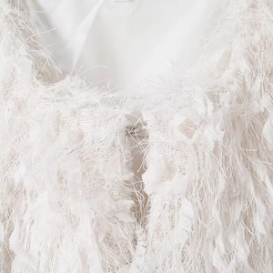 White faux fur jacket with fringe texture and a metallic hook closure detail