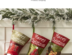 Three Christmas stockings with cartoon snowman and reindeer on a white mantel fireplace