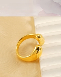Detailed view of adjustable 18k gold plated stainless steel ring with teardrop ends