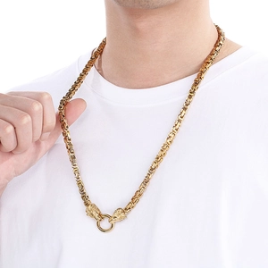 Close-up of golden lion head byzantine chain necklace for men with intricate woven details