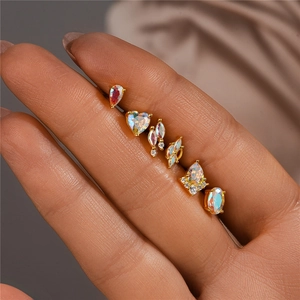 Macro detail of gold 925 silver studs set with moonstone and tiny diamonds