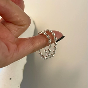 Minimalist 925 sterling silver beaded ring shown on hand with polished small round balls