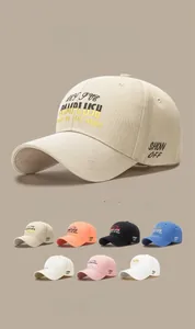 Detail of embroidered NEW LUSH logo on cotton baseball cap with multiple color swatches