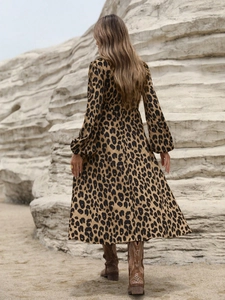 Detail view showing the leopard print pattern and lantern sleeves on a long dress