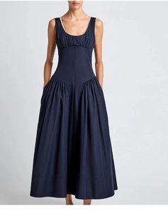 Detail view of navy blue maxi dress featuring side pleats and ruched hip silhouette