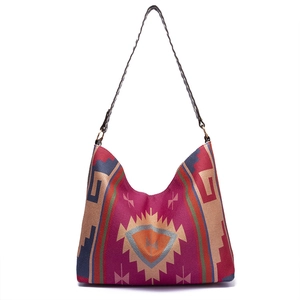 Detailed texture of bohemian hand-woven shoulder bag with colorful geometric patterns