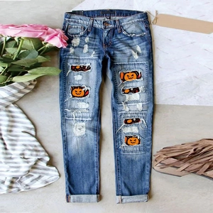 Blue distressed denim jeans with Halloween pumpkin patches and bat embroidery detail