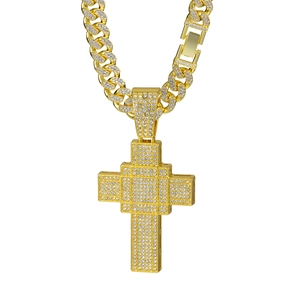 Iced out gold cross pendant on cuban link chain with zircon stones in hip hop style