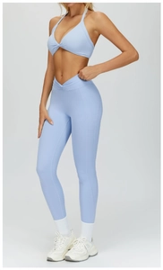 Close-up of high-waist yoga leggings with V-shaped waistband and twisted knot sports bra
