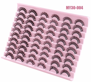 Detail view of 30 pairs of black Russian curl false eyelashes on pink tiered storage tray
