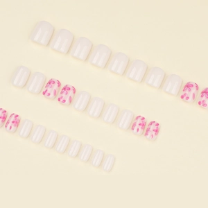 Short square milky white press-on nails set with pink flower designs and glossy finish