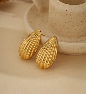 Macro shot of 18K gold plated S925 silver stud earrings with vintage vertical stripes