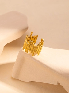 Macro detail of gold titanium steel ring with unique liquid lava texture design