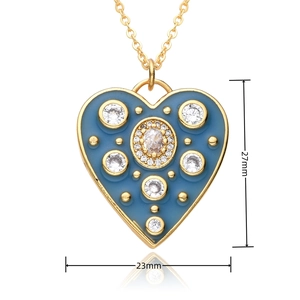 Detailed view of blue heart pendant with gold edging and dimensions 27mm by 23mm