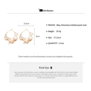 Detail view of floral hoop earrings with pearls and rhinestones showing 3cm dimensions