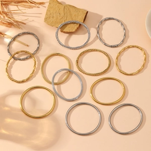 Polished stainless steel bracelets in gold and silver tones with various textures