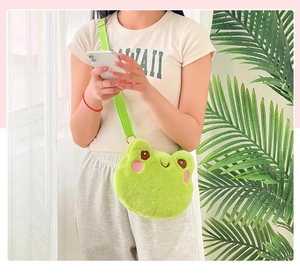 Cute green plush frog head crossbody coin purse shown on a model in a natural setting