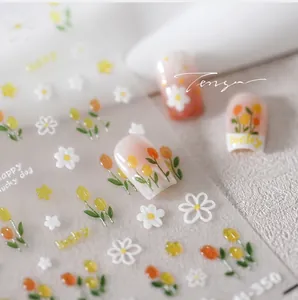 Detailed macro view of tulip floral nail art stickers with gold foil accents on base