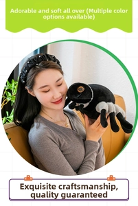 Detailed close-up of a soft black plush spider toy held in a person's arms