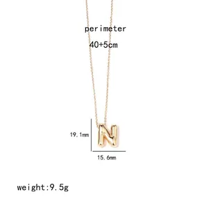Detail of gold letter N pendant showing dimensions 19.1mm height and 15.6mm width