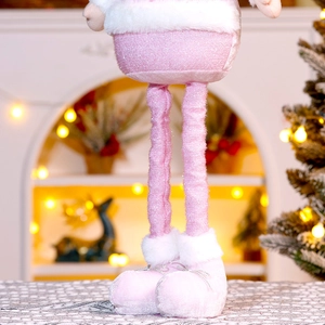 Detail of pink sequin Christmas doll with white fur trim and ribbon tied boots