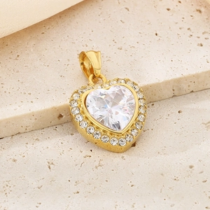 Macro shot of 18K gold heart pendant with sparkling cubic zirconia and pavé stones