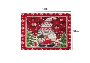 Detailed view of gnome Christmas placemat showing 43x34cm dimensions and woven fabric texture