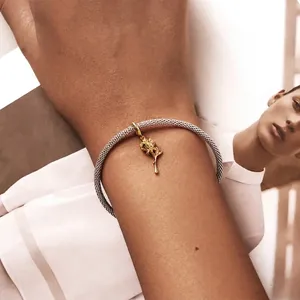 925 sterling silver mesh bracelet featuring a 3D golden rose pendant on a fashion model backdrop