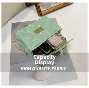 Capacity detail of mint green jelly handbag with pearls, showing cosmetics inside
