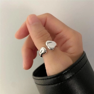 Macro detail of adjustable irregular 925 sterling silver liquid ring on hand