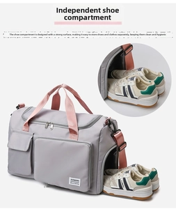 Detail view of the dedicated shoe compartment on the grey and pink sports travel bag