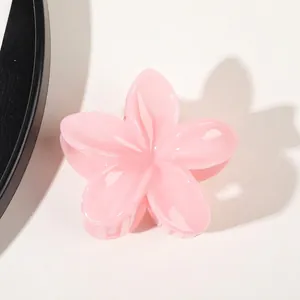 Detailed view of pink flower hair claw clip with transparent gradient resin finish