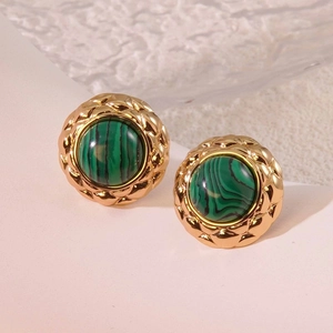 Macro detail of vintage gold stud earrings with green malachite stone and quilted pattern