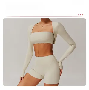 Detailed view of women's off-white three-piece yoga set with crop top and high waist shorts