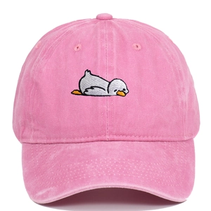 Detailed close-up of embroidered duck cartoon on a pink washed denim baseball cap