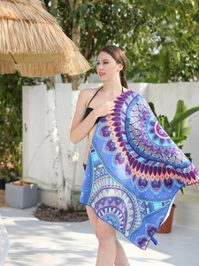 Detailed view of large mandala print beach towel with purple and orange gradient patterns