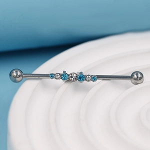 Barbell industriel argenté avec strass bleus et clairs sur support d'exposition