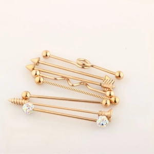 7-piece gold industrial barbell piercing set with arrow and spiral designs