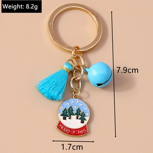 Detail of Christmas keychain with blue tassel, bell, and Merry X-mas snowball charm