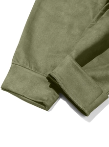 Detailed close-up of olive green faux suede fabric with precise double-stitched hem finish