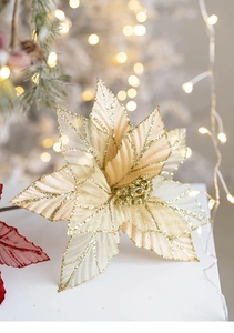 Detailed view of champagne gold velvet mesh poinsettia with glitter on a Christmas tree