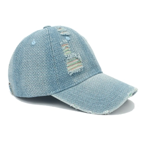 Detail of light blue denim baseball cap with distressed rainbow stitching and herringbone texture