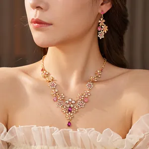 Vintage floral jewelry set with pink crystals, including necklace and drop earrings