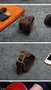 Detail view of adjustable dark brown wide leather wristband with buckle in vintage style