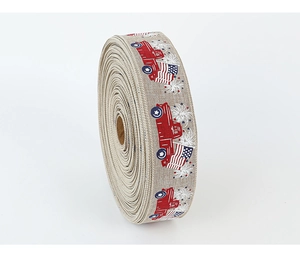 Detail of burlap ribbon roll with red truck and American flag prints for DIY decor